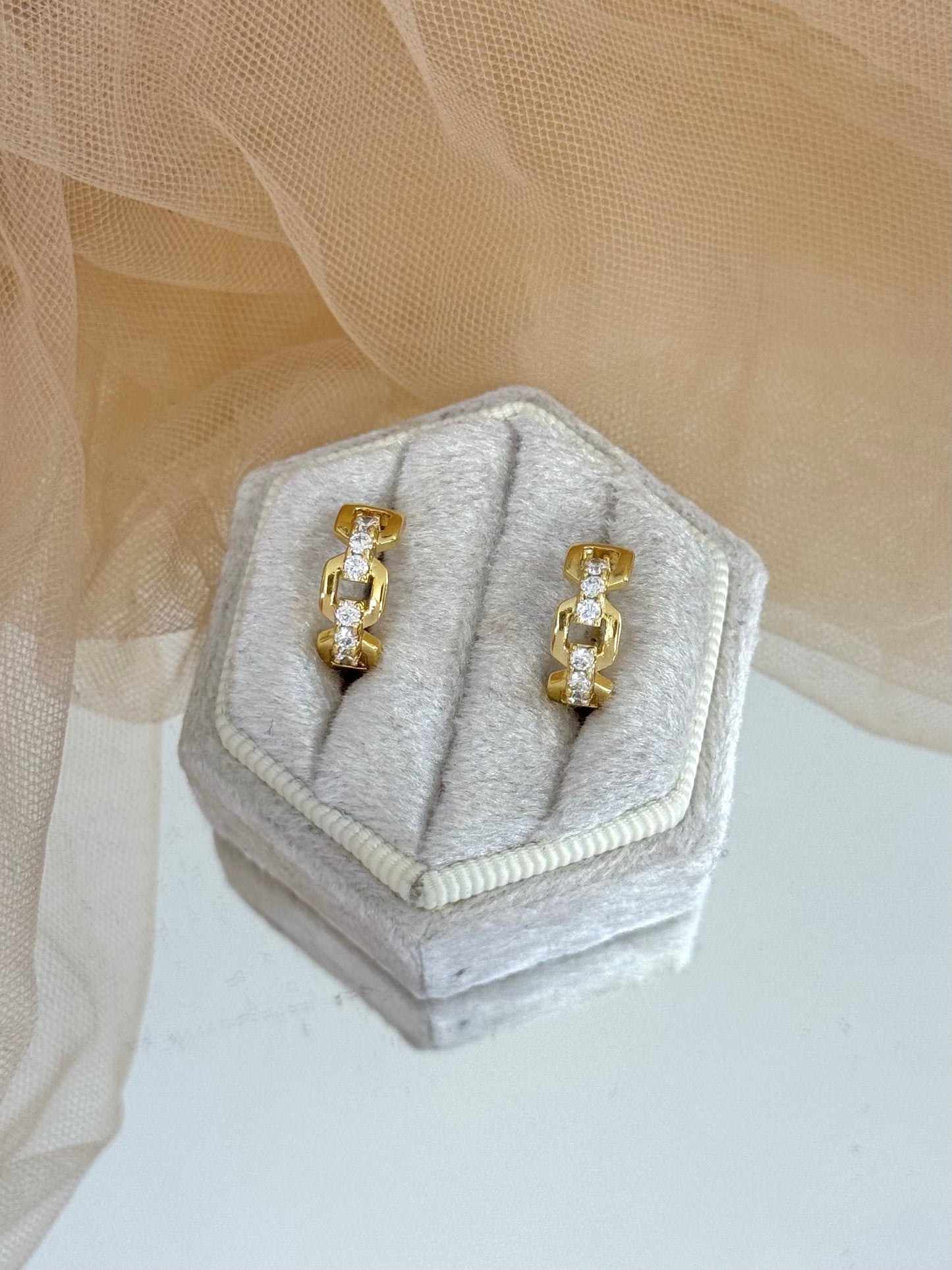 Gold hoop earrings on a hexagonal jewelry box with a soft beige background, hoop earrings, jewellery collection, everyday wear, gold studs