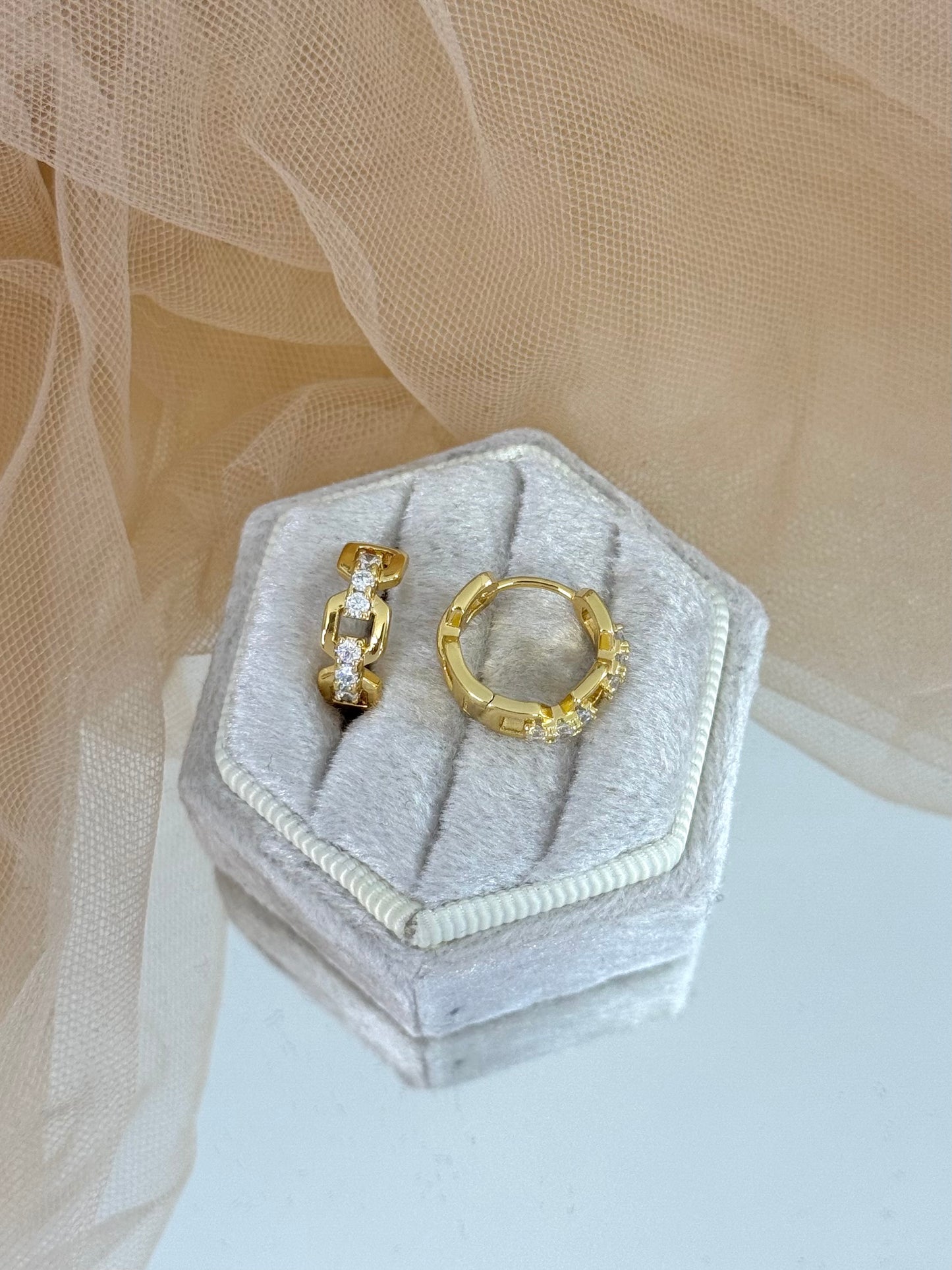 Gold hoop earrings on a hexagonal jewelry box with a soft beige background, hoop earrings, jewellery collection, everyday wear, gold studs