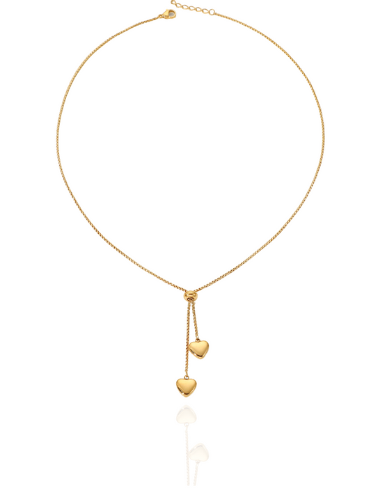 Gold necklace with heart-shaped pendants on a white background, heart pendants, partridge eye chain, formal wear, minimalist necklace, everyday wear
