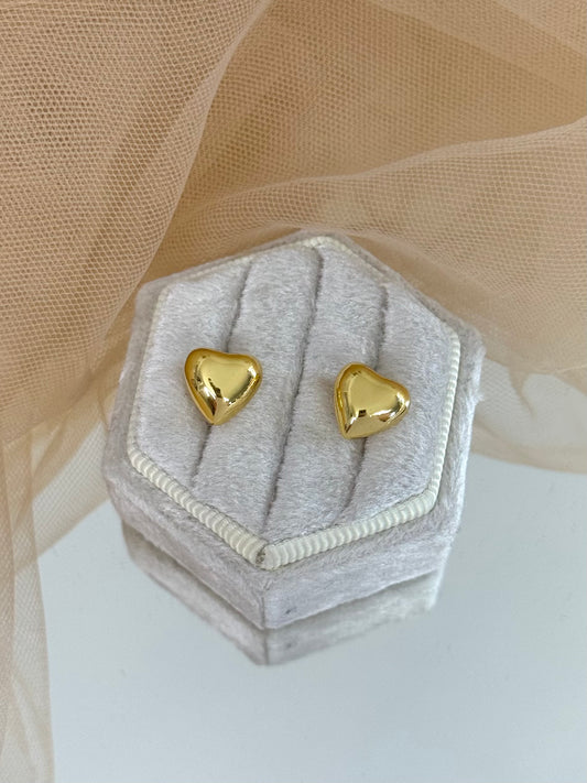 Gold heart-shaped earrings in a hexagonal gray velvet box with beige fabric background, stud earrings, elegant studs, timeless, anniversary gift, everyday wear