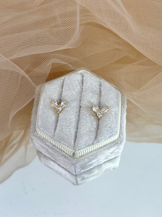 Pair of diamond stud earrings on a hexagonal gray velvet stand with beige fabric background, stud earrings, everyday wear, elegance, classy chic look, gemstone