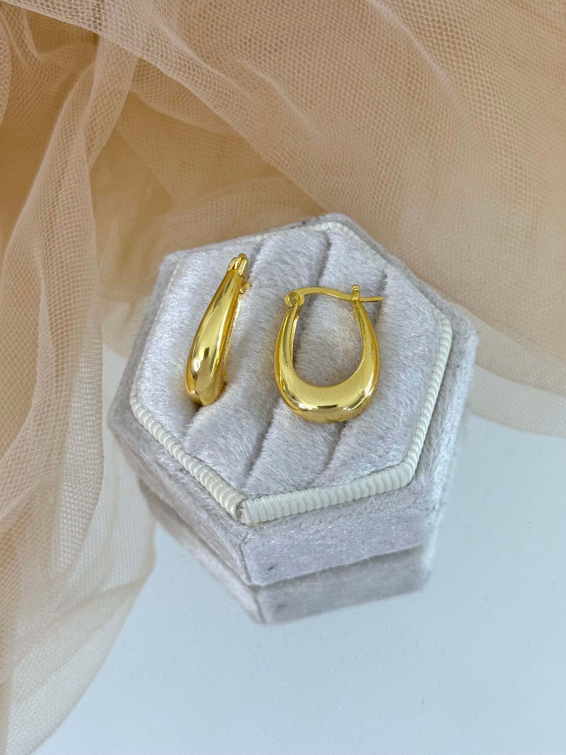 Gold hoop earrings in a hexagonal jewelry box on a light background, hoops, hoops earrings, casual wear, unique design, elegant drop earrings